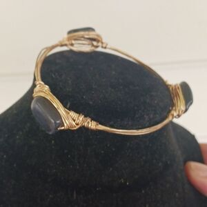 Gold toned wired bangle bracelet with black stones